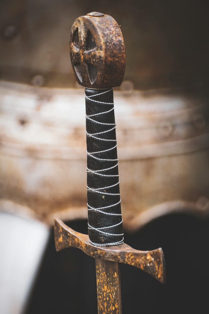 Detailed image of a rusted medieval sword handle showing age and craftsmanship.