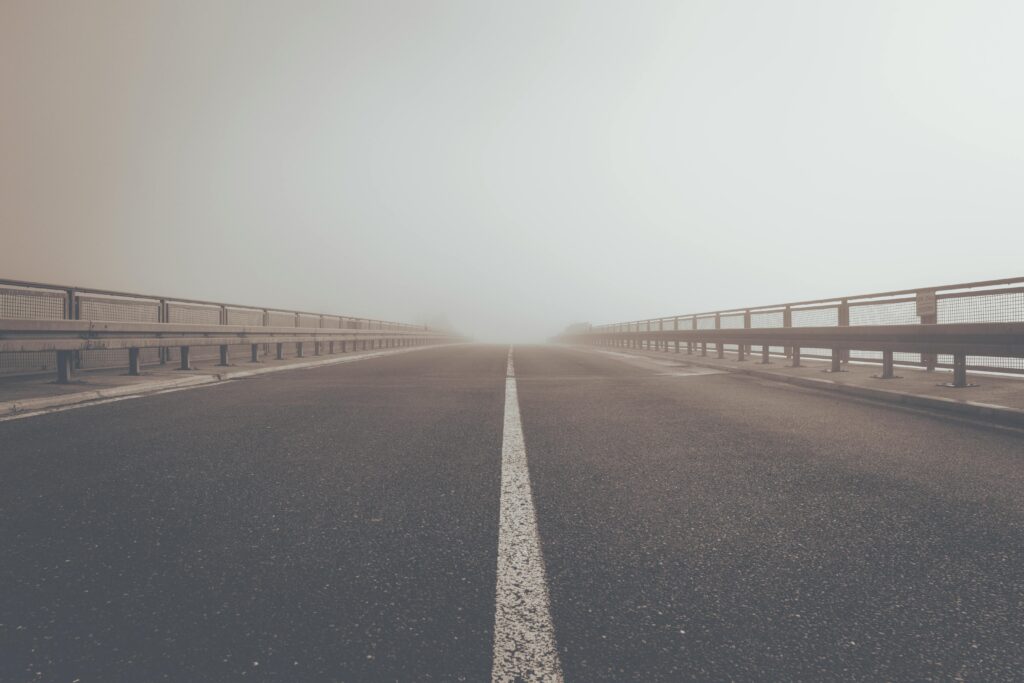 A misty road creating an atmospheric perspective and moody ambiance.